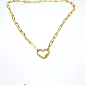 Detail of a gold paperclip chain necklace featuring a heart-shaped carabiner lock pendant