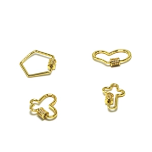 Detailed view of four gold-plated heart and cross clasps with micro-set zircons