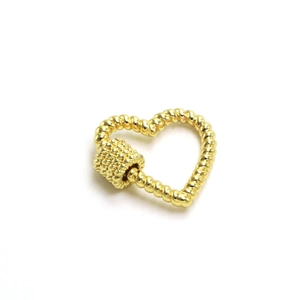 Macro shot of heart-shaped gold-plated screw clasp with twisted rope texture for DIY jewelry