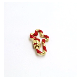 Detailed macro view of a cross-shaped gold screw clasp with red enamel candy cane stripes