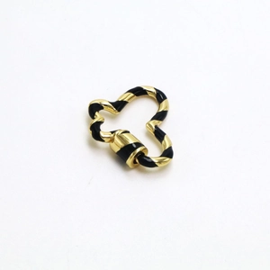 Macro shot of heart-shaped gold screw clasp with black enamel stripes for DIY jewelry making