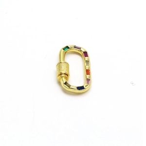 Macro view of gold-plated heart-shaped screw clasp with colorful zircon stone inlay