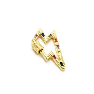 Macro shot of gold-plated lightning bolt connector with colorful rectangle zircons