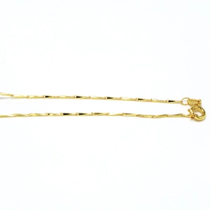 Detail shot of a delicate golden triangular prism link chain with a spring ring clasp