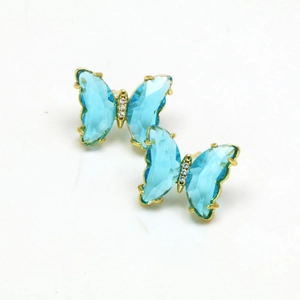 Detail of gold butterfly earrings featuring faceted sky blue crystal and zircon accents