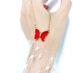 Elegant gold chain necklace featuring a dreamy red transparent crystal butterfly pendant