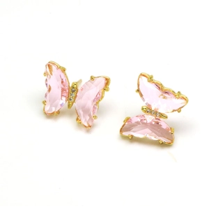 Detail of pink crystal butterfly earrings with zircon accents and gold plating