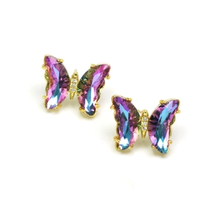 Macro view of gold butterfly earrings featuring colorful iridescent crystal wings
