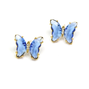 Close-up of blue crystal butterfly stud earrings with gold plating and zircon inlay