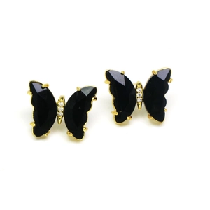 Detailed close-up of golden butterfly studs featuring black crystals and white diamonds