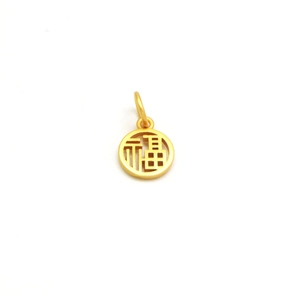 Macro shot of gold circular Fu character pendant with matte finish for DIY jewelry