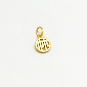 Macro detail of golden hollow charm with Chinese character pattern and matte finish