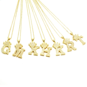 Golden crown initial necklaces with cubic zirconia pavé pendants in hip hop fashion style