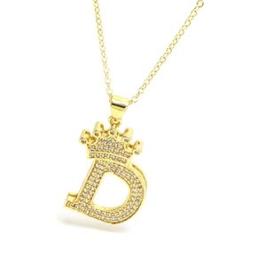 Close-up of gold crown letter D pendant necklace with sparkling cubic zirconia pavé