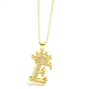 Close-up of golden crown initial E necklace with micro-paved sparkling cubic zirconia
