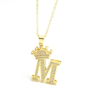 Close-up of golden crown initial M pendant necklace with sparkling zircon pave setting