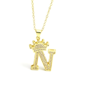 Macro view of gold crown letter N pendant featuring micro-set sparkling zircons