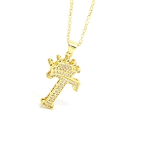 Close-up of golden crown letter F pendant with zircon micro-pave setting on chain