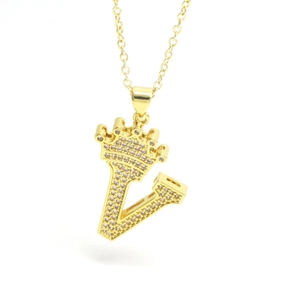 Close-up of golden crown initial V pendant with sparkling cubic zirconia pavé setting