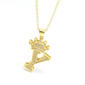 Detail of gold crown letter Y necklace pendant with sparkling cubic zirconia inlay