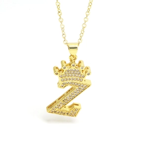 Macro shot of gold Z pendant with crown detail and micro-paved sparkling crystals