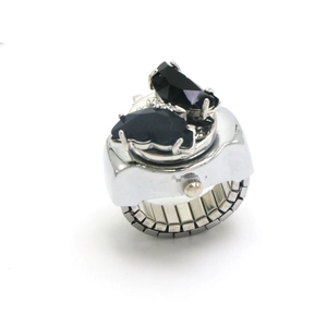 Vue macro d'une bague montre papillon avec gemmes noires et anneau argenté