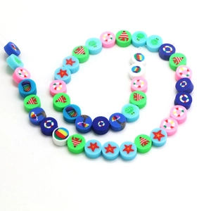 Detailed view of colorful ocean-themed polymer clay beads featuring fish and starfish