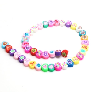 Rainbow heart-shaped polymer clay beads with colorful floral patterns for DIY jewelry
