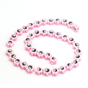 Spiral strand of pink flower beads with yin yang patterns for DIY jewelry making