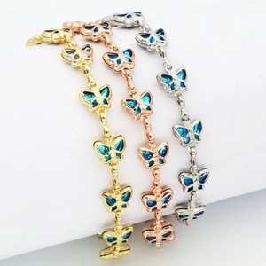 Detailansicht von Schmetterlingsarmbändern in Gold, Roségold und Silber mit Steinen
