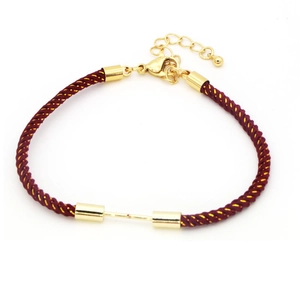 Detailed macro of red nylon braided bracelet with gold lobster clasp and extension chain