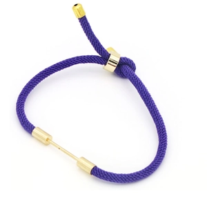 Detailed view of purple woven cord bracelet with adjustable gold metal closure buckle