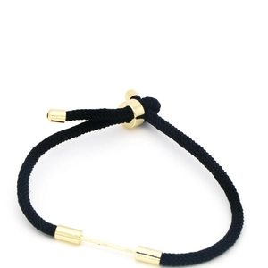 Detail view of adjustable black braided rope bracelet with polished gold cylinder clasp