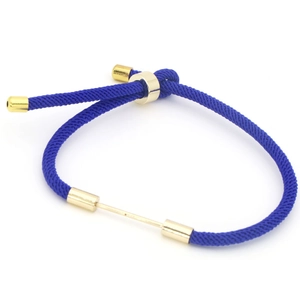 Detail of adjustable dark blue braided cord bracelet with polished gold metal hardware