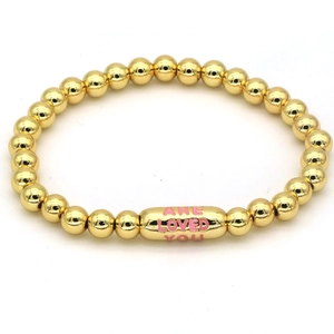 Polished 18k gold beaded bracelet featuring a capsule charm with pink engraved text