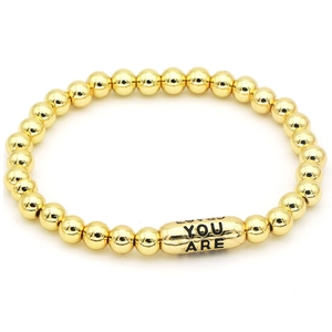 Detailed shot of 18k gold-plated beaded bracelet with You Are Loved engraved cylinder bead