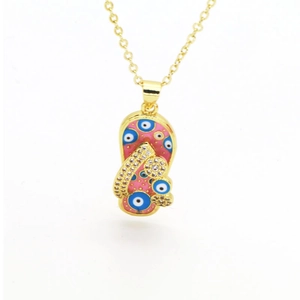 Detail of pink flip-flop pendant with evil eye pattern and zircon strap on gold chain