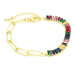 Dettaglio di bracciale a catena a graffetta dorata e tennis di zirconi arcobaleno chic