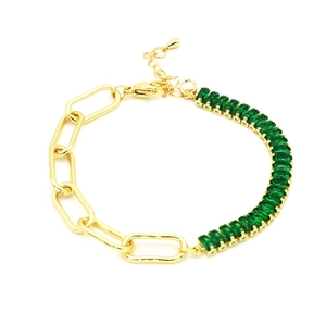 Dettaglio del bracciale dorato con zircone verde smeraldo e maglie a graffetta