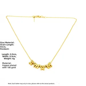 Close-up of Mama pendant necklace in 18k gold plated copper with lobster clasp detail