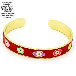 Detail showing 18k gold plated copper bangle with red enamel evil eye and Hamsa patterns