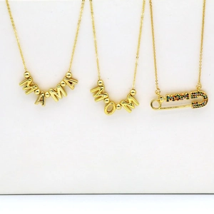 Detailed view of gold Mama and Mom letter necklaces with colorful crystal pin charms