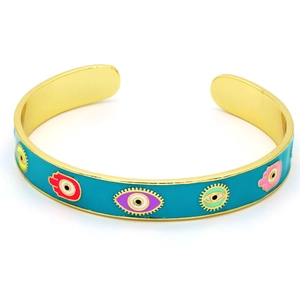 Macro detail of the golden Hamsa hand and blue evil eye charms on the enamel bangle