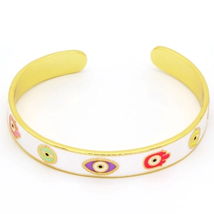Detail view of gold adjustable cuff featuring colorful enamel Evil Eye and Hamsa Hand charms