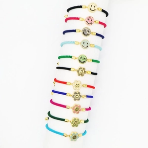 Detailed set of colorful braided bracelets with gold-plated zircon smiley face charms