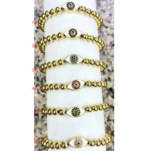 Detailed view of evil eye beaded bracelets with six colorful zircon charms and gold beads