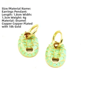 Detail of 18k gold plated enamel earring with mint green grid pattern and oval design