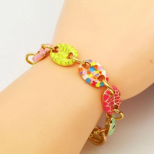 Close-up of golden link bracelet featuring colorful mosaic enamel coffee bean charms