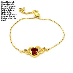 Detail of adjustable 18k gold plated copper bracelet with a red zircon heart pendant