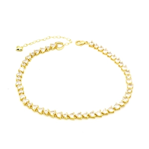 Detail of gold heart-shaped tennis chain showing lobster clasp and extension chain